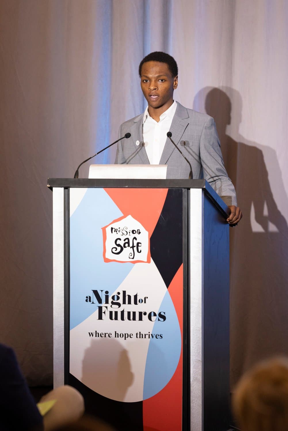 Smiling woman giving a piggyback ride to a laughing young girl.